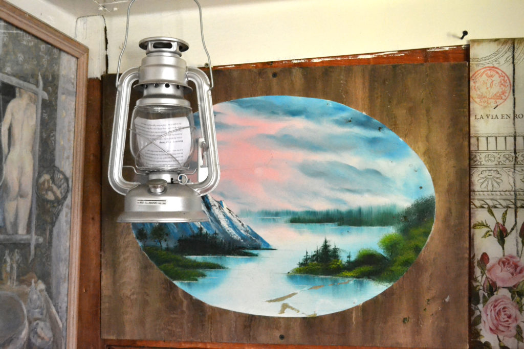 lantern hanging in front of a painted seascape