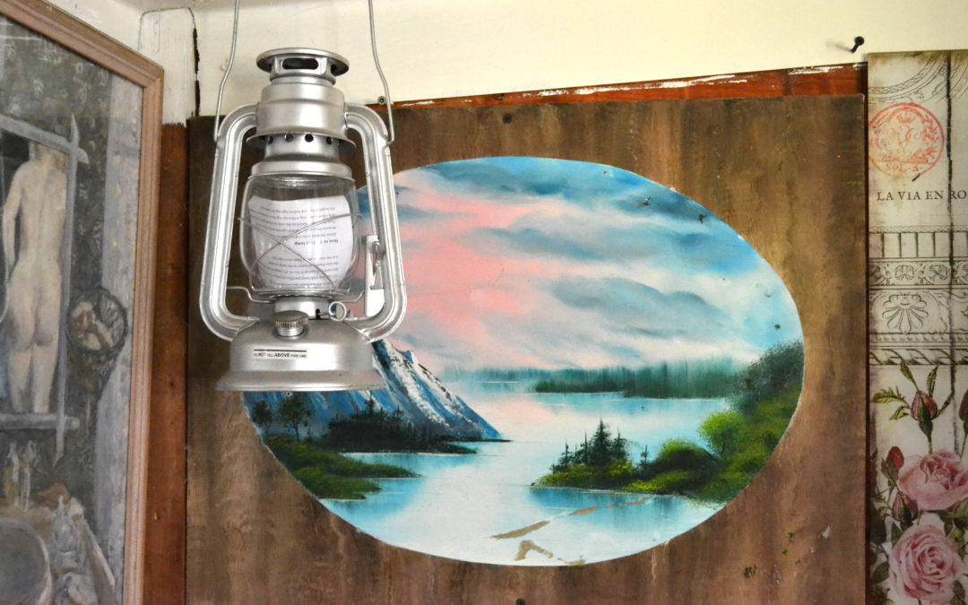 lantern hanging in front of a seascape on a door
